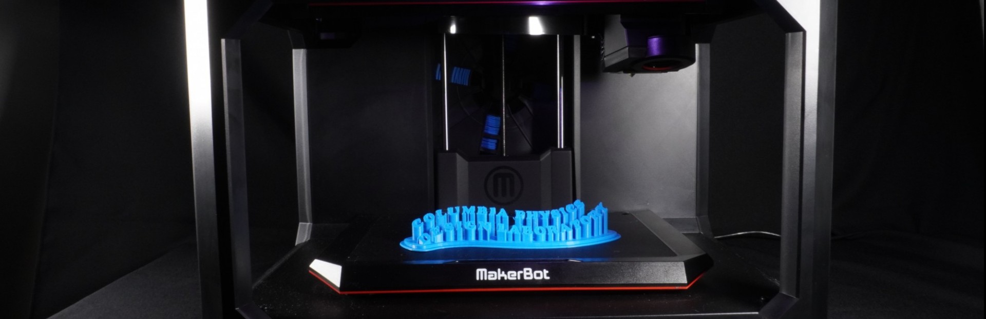 Image of a MakerBot Replicator+ 3D printer with a 3D printed logo saying "Columbia Physics Design Lab"